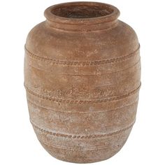 a large brown vase sitting on top of a white table