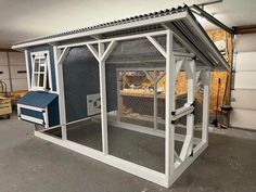 a large chicken coop in the middle of a garage