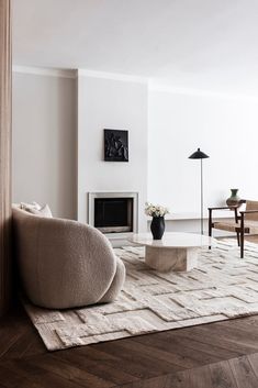 a modern living room with white walls and wood flooring is pictured in this image