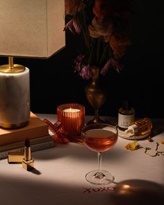 a table topped with a glass filled with liquid