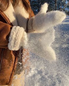 a person throwing snow into the air