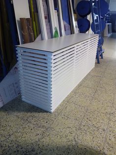 a large white radiator sitting on top of a floor next to a wall