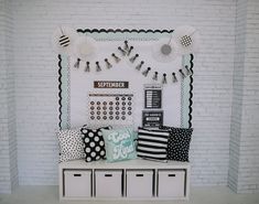 a white brick wall with black and white pillows on it's sides, along with other decorative items