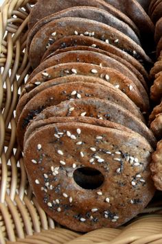 a basket filled with bagels covered in sesame seeds