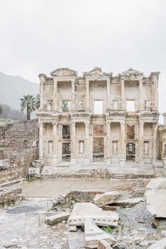 an old building with many windows in the middle of it's rubbleed area