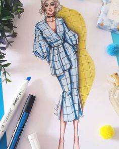 a drawing of a woman in a blue dress on top of a table next to some pens and markers