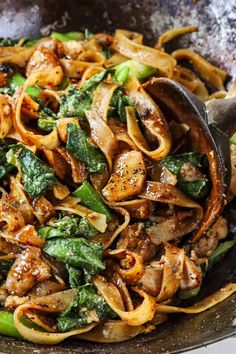 a skillet filled with pasta and vegetables