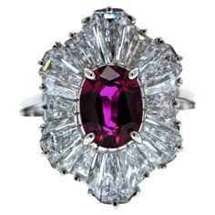 This is a vivid pink 2.00 carat oval cut, gem quality, fancy pink sapphire. Its gem source is Sri Lanka. Its transparency and luster are excellent. It has a halo of mixed cut diamonds that total .99carats. Created in platinum. Crossover Diamond Ring, Contemporary Jewelry Design, Beautiful Tiaras, Elegant Engagement Rings, Platinum Diamond Rings, White Gold Sapphire, Tanzanite Diamond, Contemporary Ring, Halo Diamond Ring