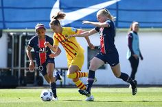 two girls are playing soccer against each other