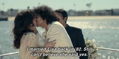 a man and woman kissing on the deck of a boat in front of water with text that reads, i married usa back in 82 still can't believe she said yes