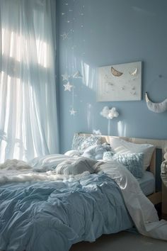 a bedroom with blue walls and white curtains