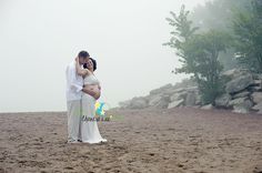 a man and woman standing on top of a sandy beach next to eachother