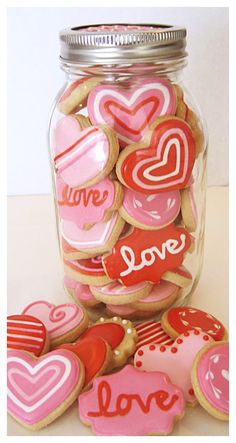 a jar filled with lots of heart shaped cookies