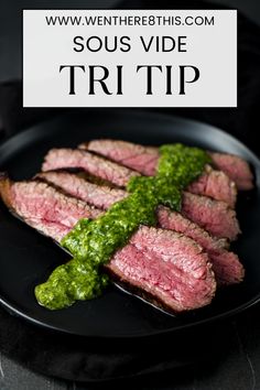 grilled steak with pesto sauce on a black plate