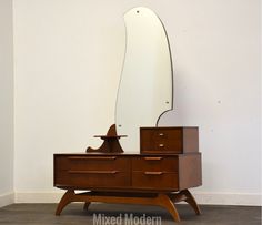 a wooden dresser with a mirror on top of it