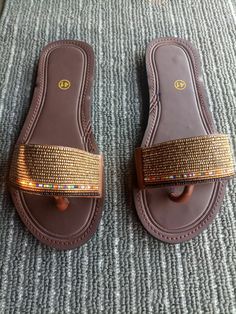 Unique Gift | Sandals | Gladiator Sandals | Greek Sandals | Beach Jewelry | Wedding Shoes | Leather Sandals | Custom | Mothers Gift An elegant and authentic pair of African inspired beaded ladies sandals, with a unique and eye-catching design. 100% genuine leather. Color -Copper & a maasai & black line .   *100%  Handmade.    S I Z E  C H A R T  EUUSAUKCMINCHES 343.51.522.38.8 354.52.5239 365323.69.3 376424.29.5 387524.99.8 398625.510 4096.526.110.3 4110726.810.6 4211827.510.8 4312928.211.1   ♥ Brown Beaded Open Toe Flip Flops, Adjustable Brown Beaded Sandals, African Sandals, Beach Wedding Jewelry, Beaded Sandals, Maasai, Greek Sandals, Women Sandals, Beach Jewelry