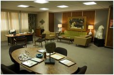 a living room filled with lots of furniture next to a table and chairs in front of a window