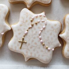 decorated cookies with beads and a cross on them