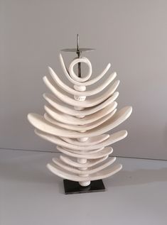 a white ceramic christmas tree sitting on top of a table