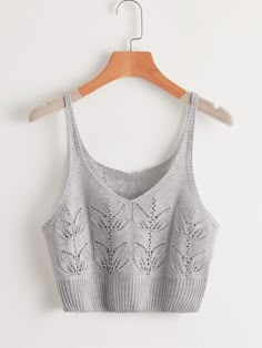 a cropped top hanging on a wooden hanger