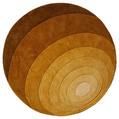 four round rugs in various colors on a white background