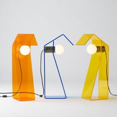 three different colored lamps sitting next to each other