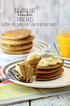 banana oat pancake cut in half on a plate with a fork and glass of orange juice