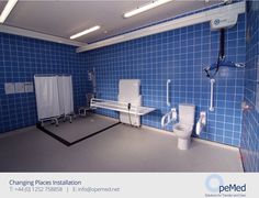 an empty bathroom with blue tile walls and floor