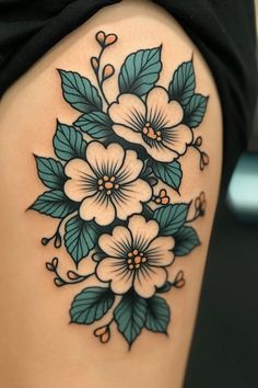 a woman's thigh with flowers and leaves on it