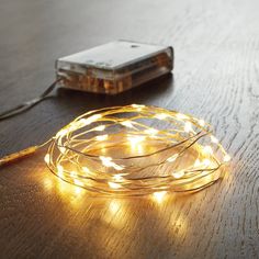 a string of lights on a table next to a cell phone