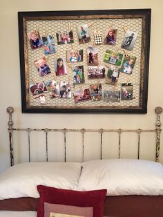 a white bed topped with pillows and pictures