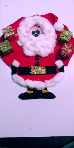 a santa clause doll with lots of presents on it