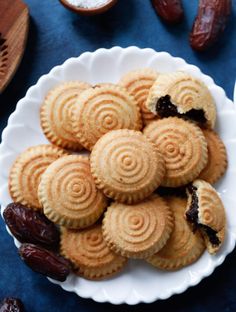 a white plate topped with cookies and raisins on top of a blue table