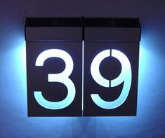 the numbers are lit up in front of a white background and black box that says 39