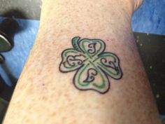 a person with a shamrock tattoo on their leg