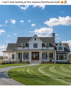 a large white house sitting on top of a lush green field