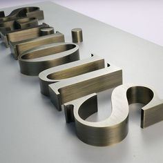 the metal letters are lined up on the table