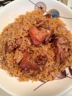 a white plate topped with rice and meat