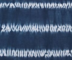 blue and white tie - dyed fabric with vertical stripes