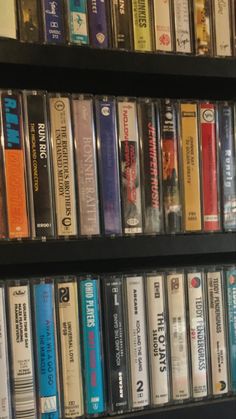 a shelf filled with lots of different types of cd's