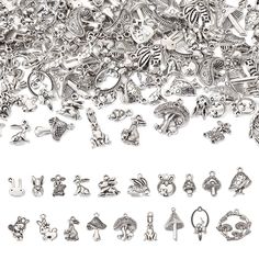 a pile of silver colored charms on a white background