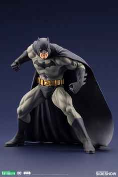 the batman action figure is posed on a blue background