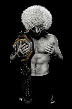 a man with an afro holding a wrestling ring