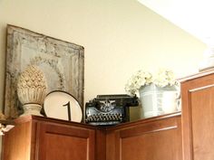 an old fashioned typewriter sitting on top of wooden cabinets