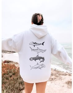 Dive deep into style with our Hammerhead Shark Sweatshirt - the apex of ocean-inspired fashion! This sweatshirt is more than just apparel; it's a fin-tastic statement for shark enthusiasts. The finely embroidered hammerhead shark design adds a touch of whimsy and uniqueness, making it a standout piece in your wardrobe. Crafted from cozy fabric, this sweatshirt provides both comfort and style, whether you're navigating the urban jungle or cruising through a sea of responsibilities. It's the perfe Casual White Shark Design Tops, Shark Merchandise, Ocean Sweatshirt, Shark Background, Shark Clothes, American Student, Hammerhead Sharks, Shark Jewelry, Shark Sweatshirt