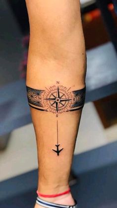 a person with a compass tattoo on their leg