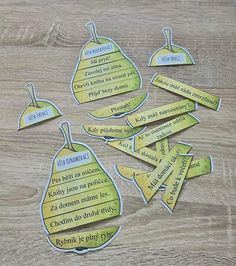 several pieces of cut out paper with words on them sitting on a wooden table next to each other