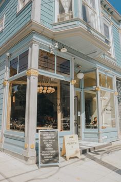 a blue building with white trim and windows