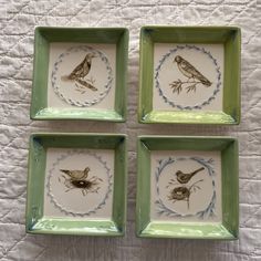 four green and white plates with birds on them