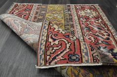 two rugs laying on the floor next to each other with different colors and patterns